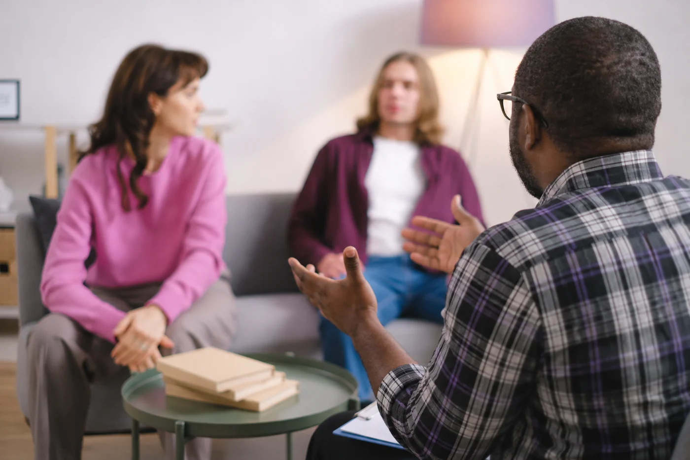 A counselor meeting with two adults