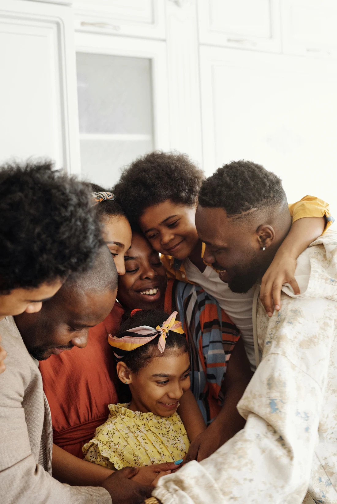 A family sharing a close embrace at home
