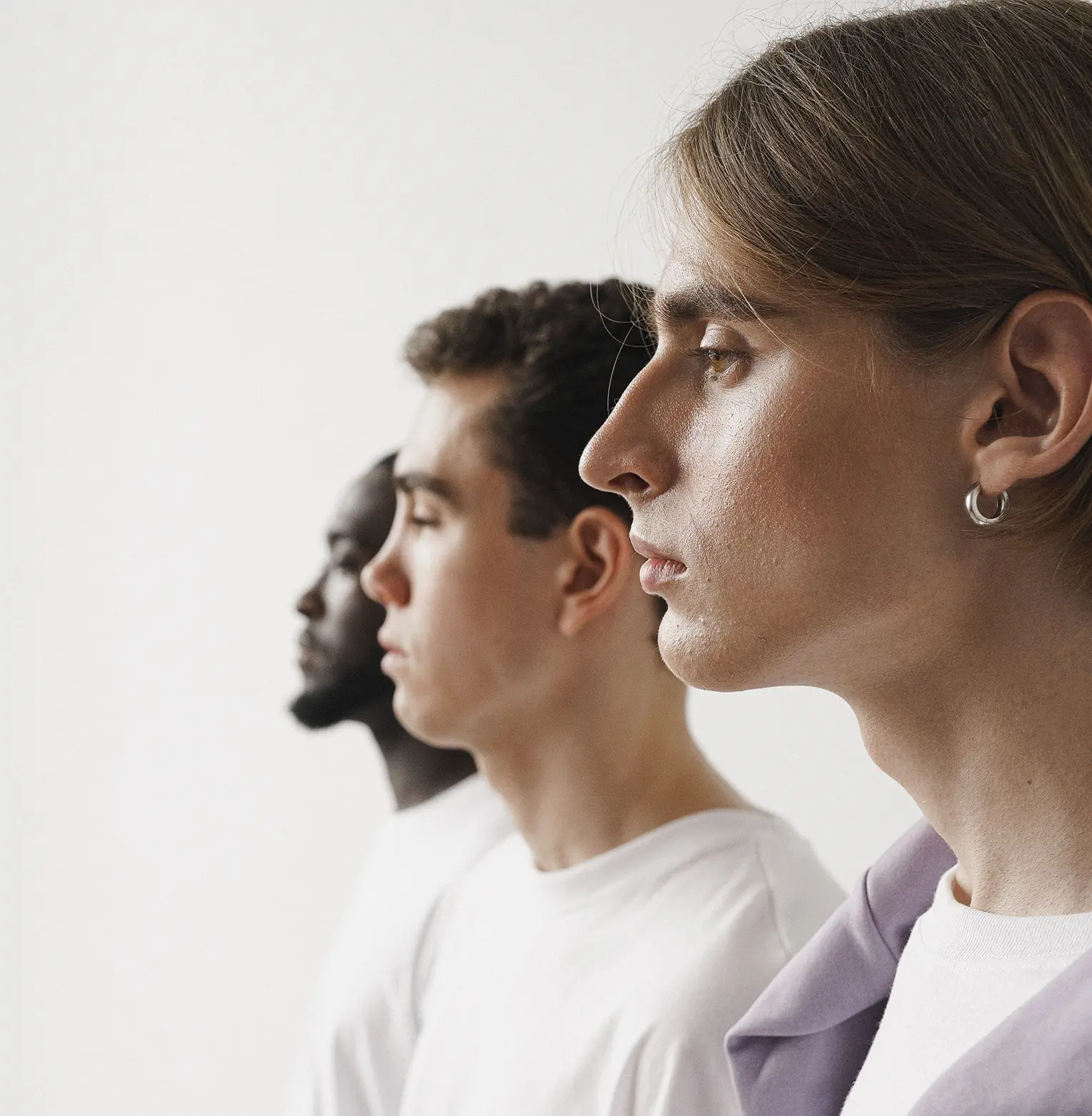 Three adults shown in profile