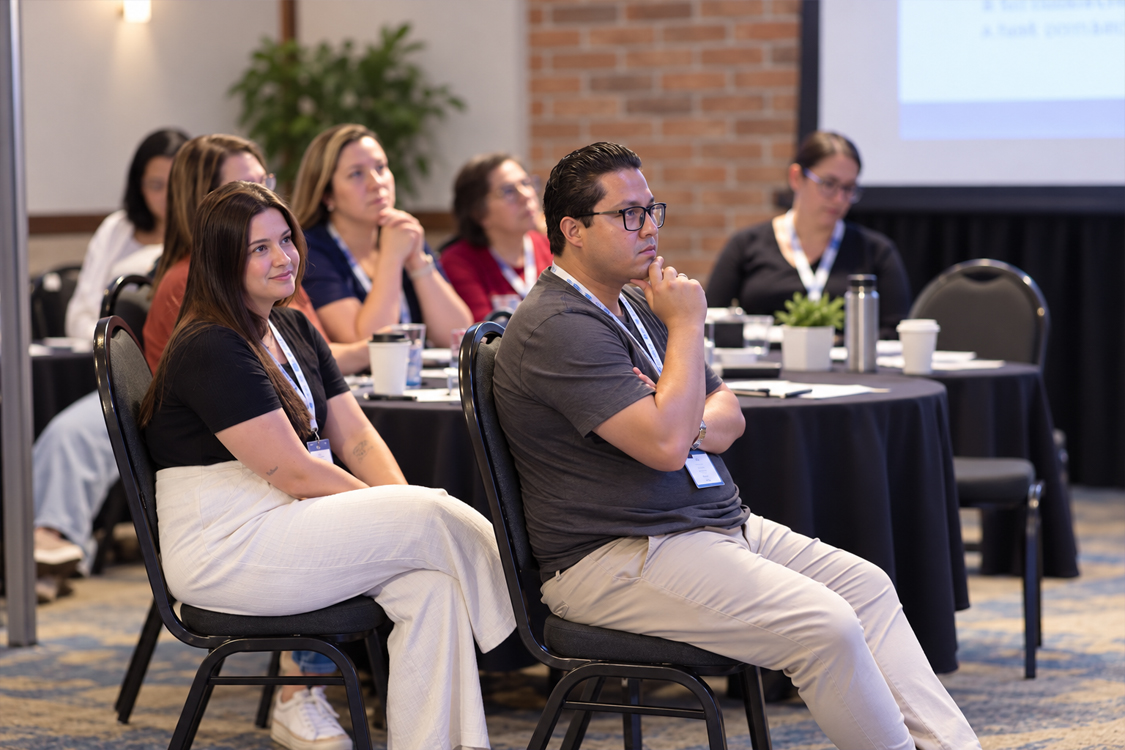 Adults listening attentively at a community workshop
